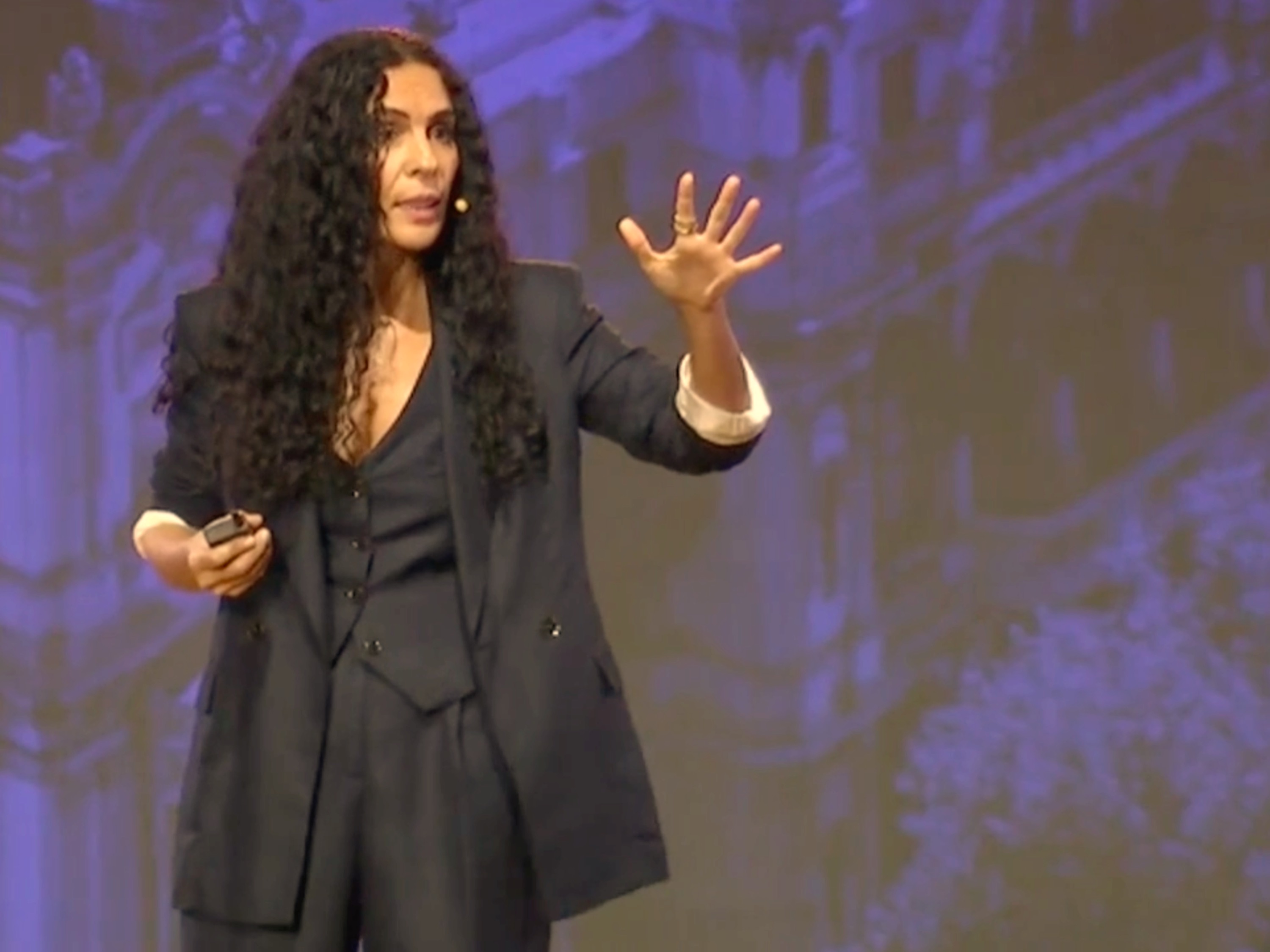 Aline J. Badr speaking on stage