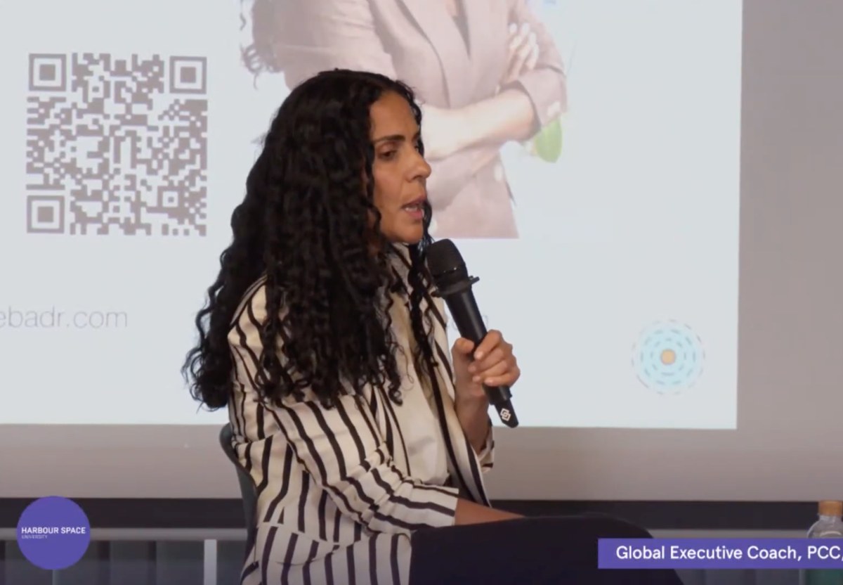 Aline speaking into a microphone at Harbour.Space University
